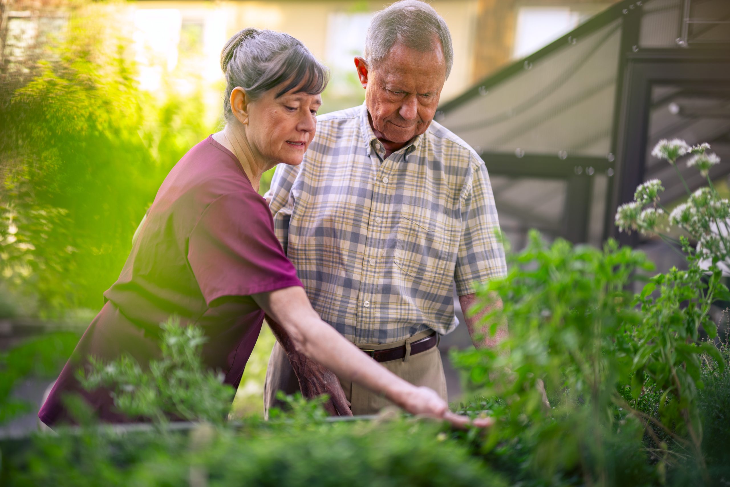 Touchmark team member and resident in garden